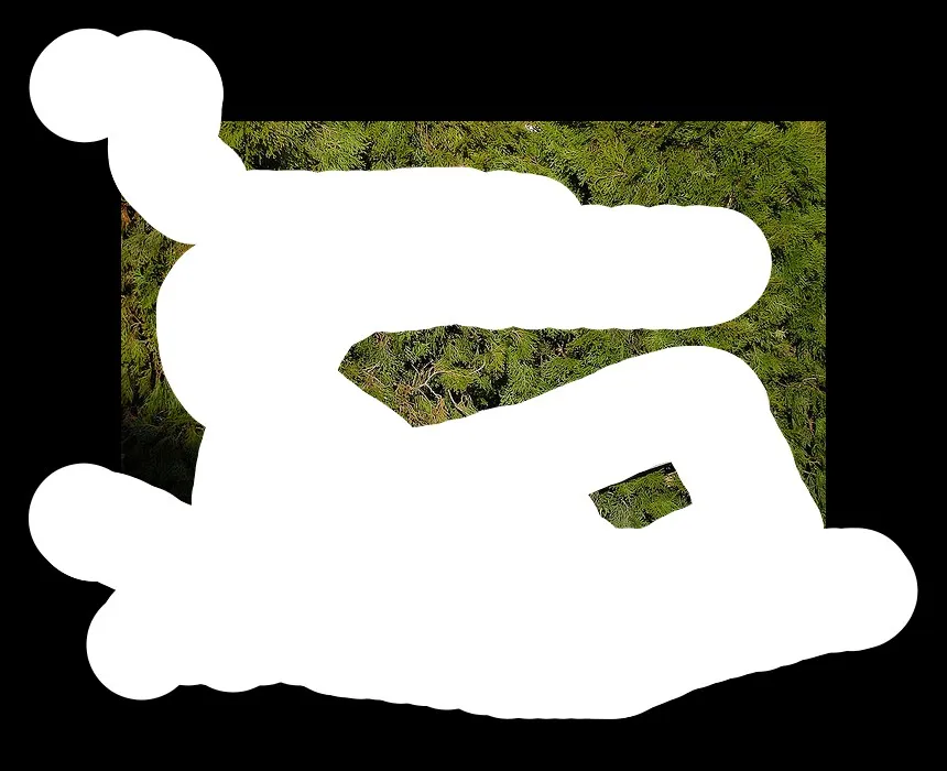 Delocalized Narratives #39 In this image, in the middle there is a white color object, in the background there are some green color trees, there is a brown color wall